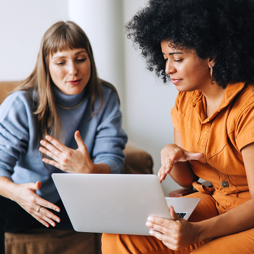 Two people using a laptop