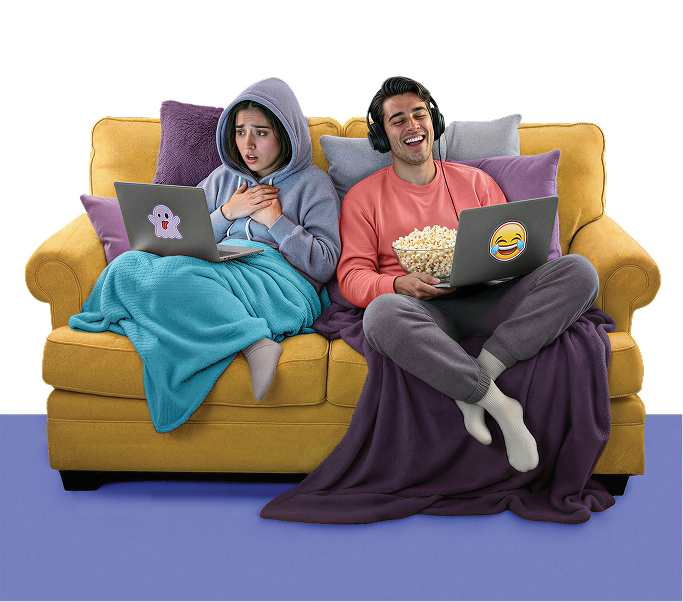 Two people sitting on a couch using laptops