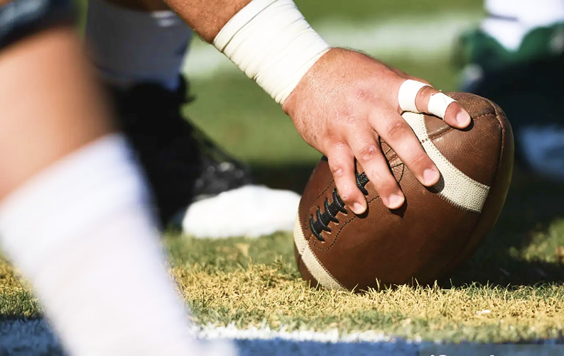 A center preparing to snap a football